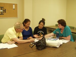 RSVP volunteer Jeff Knezel tutors Leticia Leon and Maria Leon, along with volunteer tutor Linda Kilas (right), during a financial literacy class held at First United Methodist Church in Appleton. Kilas is president of the board of Literacy Education Services, Inc., which provides classes to adults so they can achieve their maximum potential. 