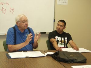 RSVP volunteer Tom Stenklyft (left) facilitates a financial literacy class that includes student Gustavo Solares, at First United Methodist Church in Appleton. 