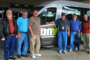 Veterans James Stone (from left), Clem Balthazor, Jim Stern and Dennis Runyan (second from right) await transportation by volunteer driver Gerry Arens (right) at the Appleton clinic. Cal Gardner (third from right) also is a longtime volunteer driver for veterans. 